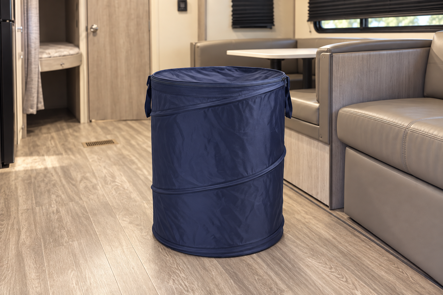 Navy collapsible hamper in a styled camper interior