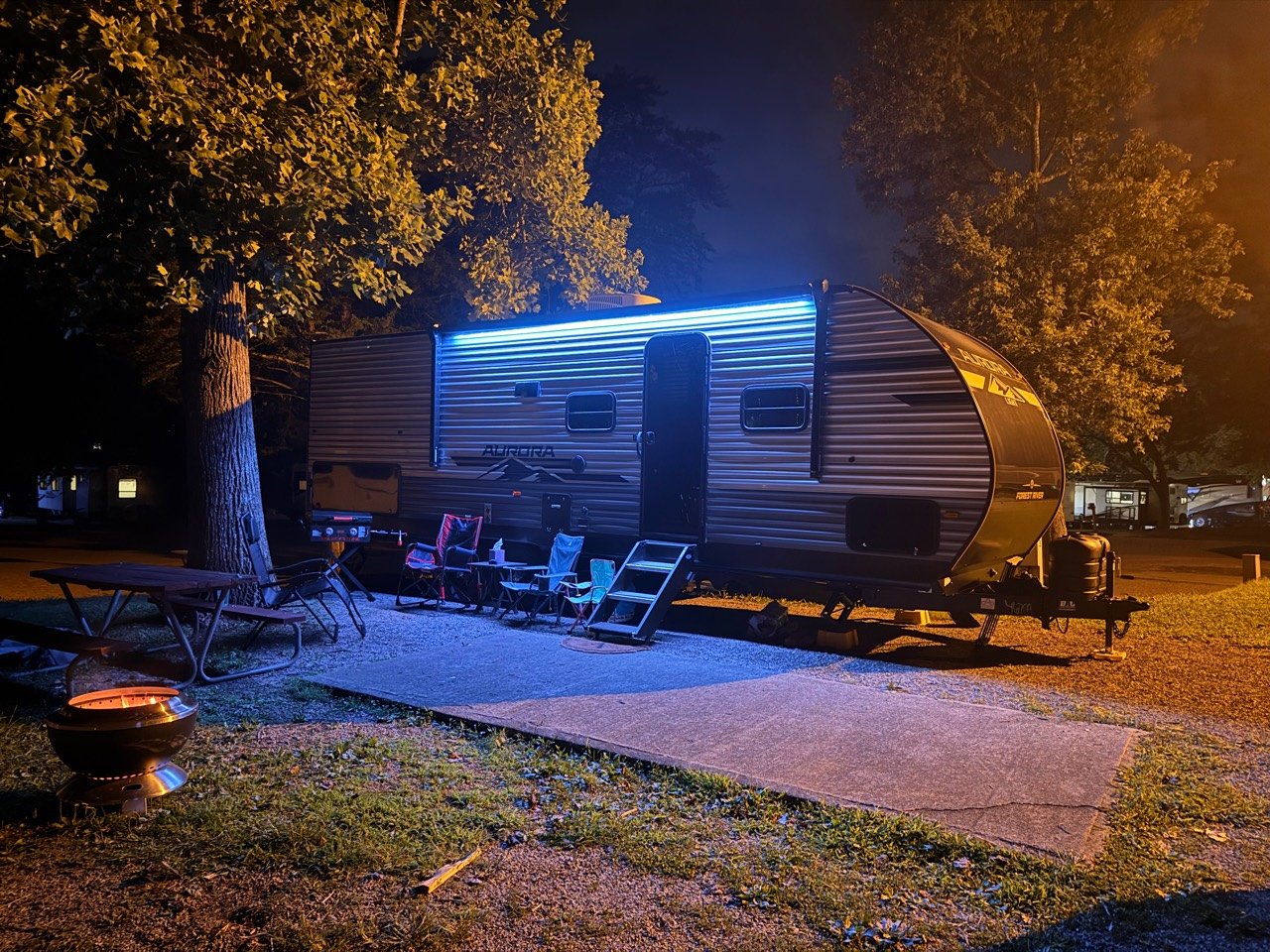 Our Aurora Light travel trailer set up at the campground at night