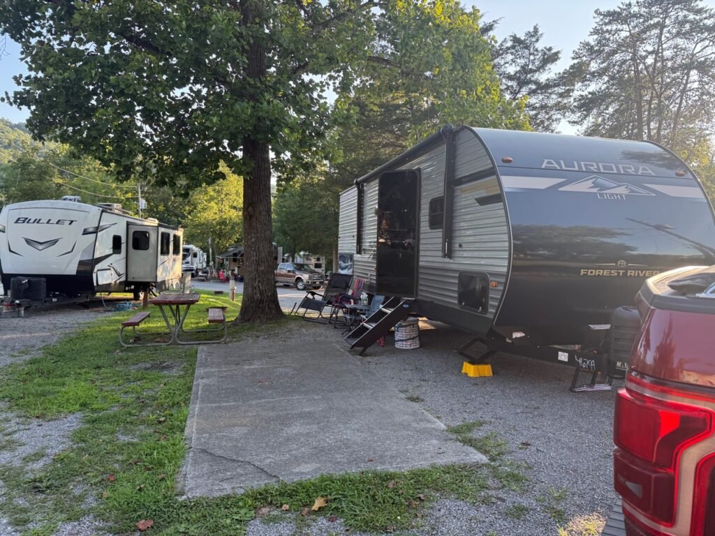 Our Forest River Aurora Light travel trailer set up at a family campground