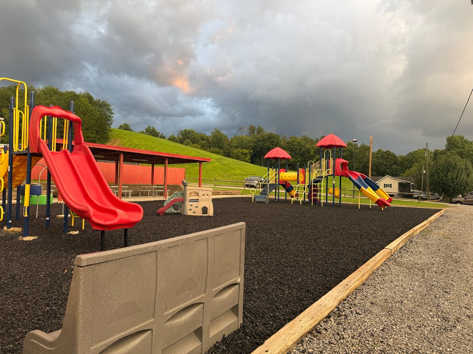 Colorful playground equipment and slides in the upper recreation area at Clabough's Campground.