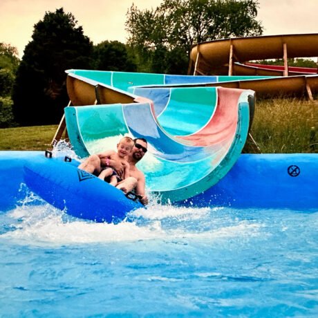 Guests enjoying a pool slide at Lake Ridge RV Resort