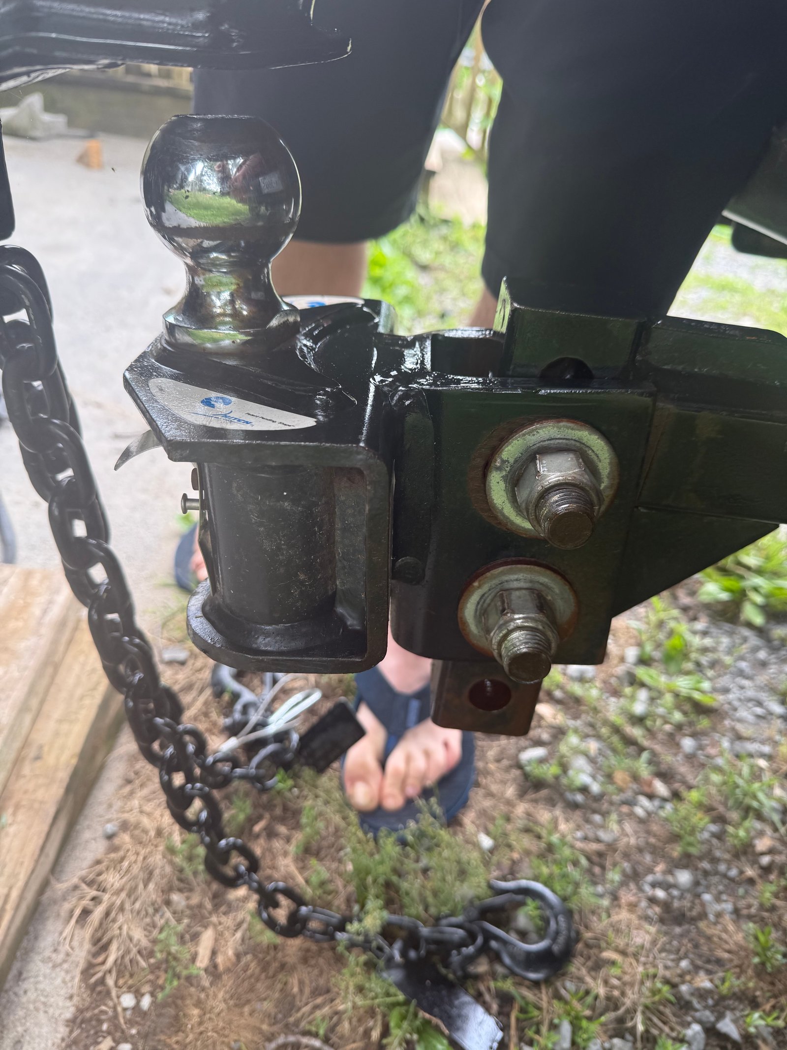 Close view of our weight-distribution hitch coupler and safety chains